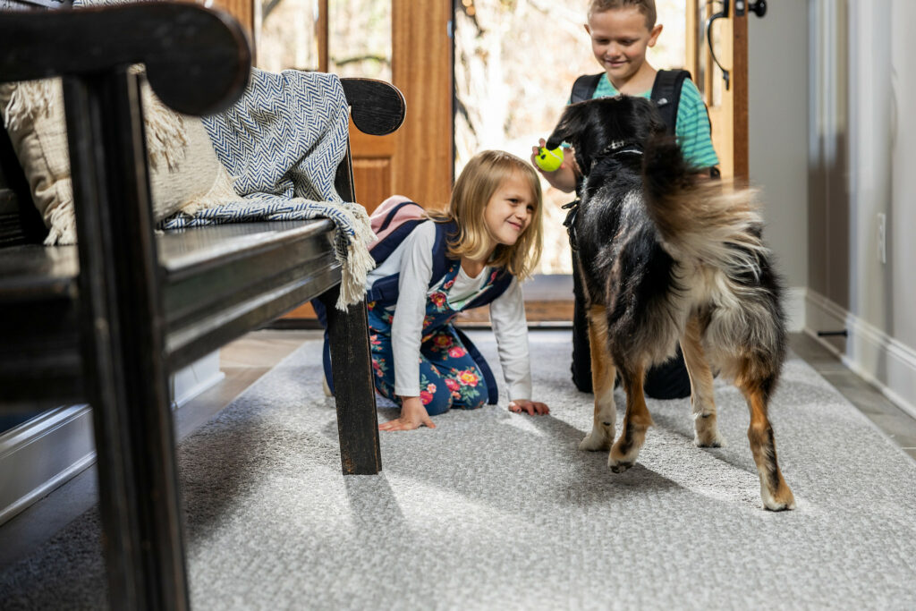 Kids playing with dog on carpet floors | Mill Direct Floor Coverings